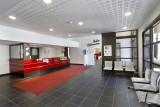 Residence reception area, tiled floor, reception desk, waiting chairs, door to lounge