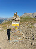 Stone marker at Pas du Lausson, 2,602 m, situated on a promontory and indicating several directions