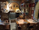 Interior of the crêperie, Christmas decorations, wood and stone, dining tables and chairs