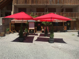 View from the crêperie terrace in summer, terrace with parasols and benches