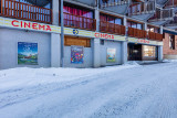 Cinema facade in winter, window display with posters