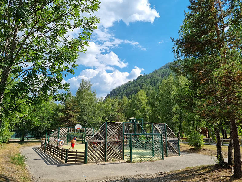 Enclosed basketball and soccer field, in the middle of the trees