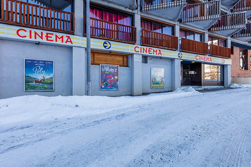 Cinema facade in winter, window display with posters
