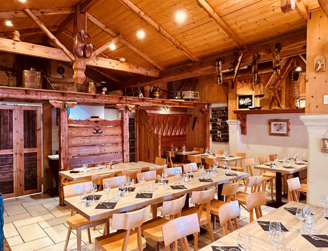 Restaurant dining room, wooden tables and chairs, interior decoration and wooden roof, warm atmosphere