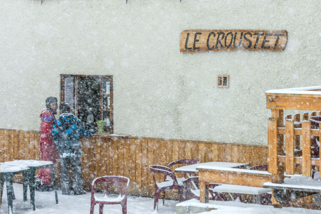 Detail of the restaurant's facade with the wooden sign 
