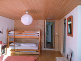 bright bedroom with double bed and bunk beds