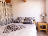 Bright bedroom with double bed, wooden furniture, windo