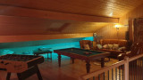 Games room in the attic on the mezzanine level, foosball table, pool table, sofa and leather armchairs
