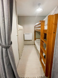 Bedroom area of the apartment, bunk beds, separated by curtains