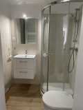 Modern bathroom with shower tray, sink, mirror