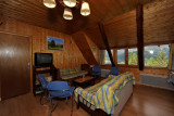 Fully equipped apartment living room, sofa, coffee table, TV, wooden furniture, window