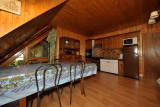 Fully equipped apartment living room, large dining table, kitchen, wooden furniture