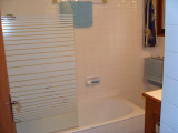 Tiled bathroom with bathtub