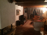 Living room with sofa, armchairs, TV, rug, window