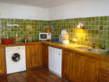 Kitchenette with electric hobs, wooden furniture, tiles
