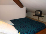 Attic bedroom with double bed, TV, wooden furniture