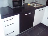 Modern kitchenette with electric hobs and microwave