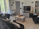 Bright living room with sofa, armchair, indoor furniture, TV