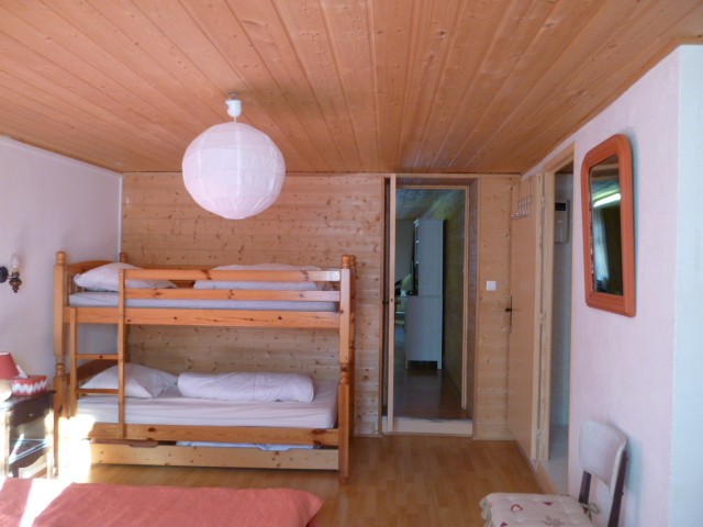 bright bedroom with double bed and bunk beds