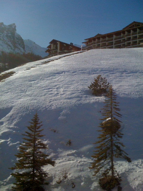View of the flat from below with snow-capped mountains
