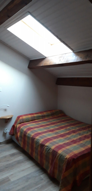 Bedroom in the attic with double bed, parquet flooring, skylight - © M Miserandini Bedroom in the attic with double bed, parquet flooring, skylight