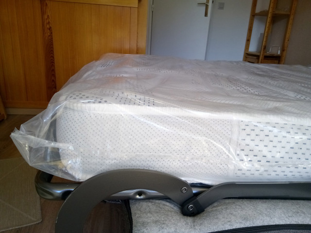 Bedroom with folding double bed, wooden furniture