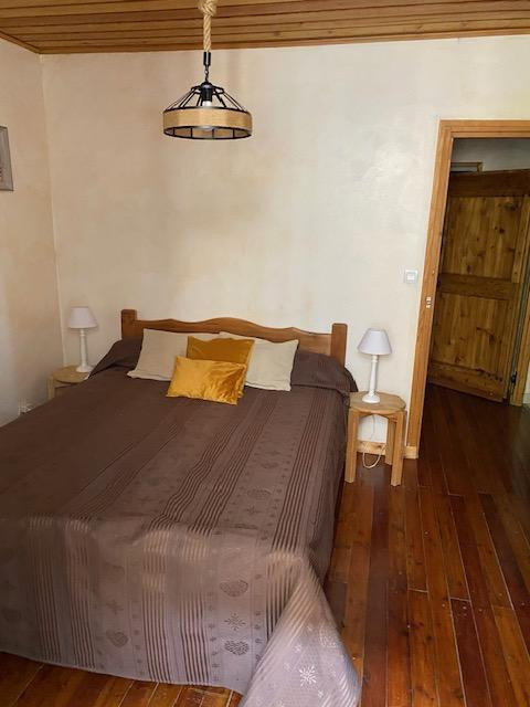 Bright bedroom with double bed, wooden furniture