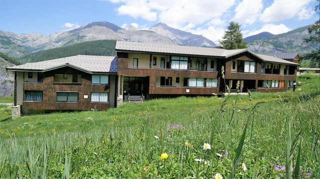 Vue extérieur du lotissement, en bois, côté prairie, avec vue sur les montagnes Vue extérieur du lotissement, en bois, côté prairie, avec vue sur les montagnes