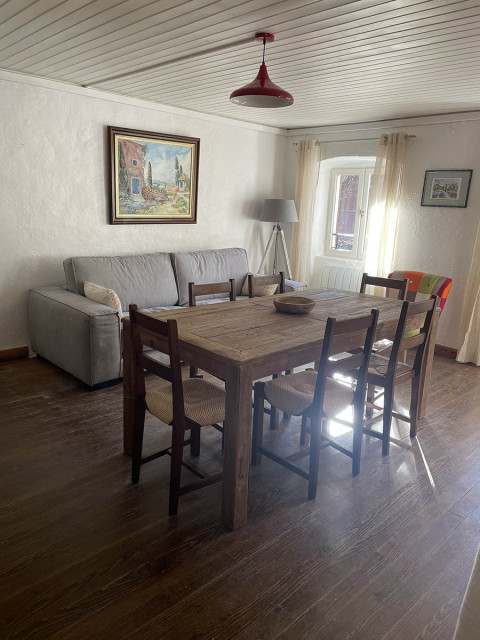 Bright living room with dining table, sofa, wooden furniture, window