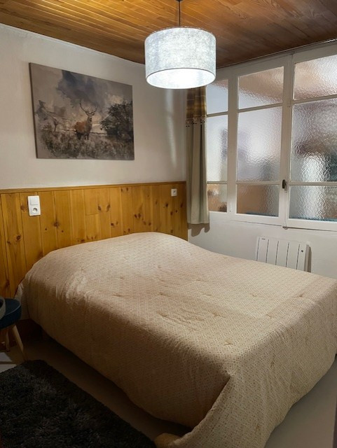 Bright bedroom with double bed, cathedral glass partition