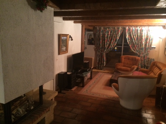 Living room with sofa, armchairs, TV, rug, window